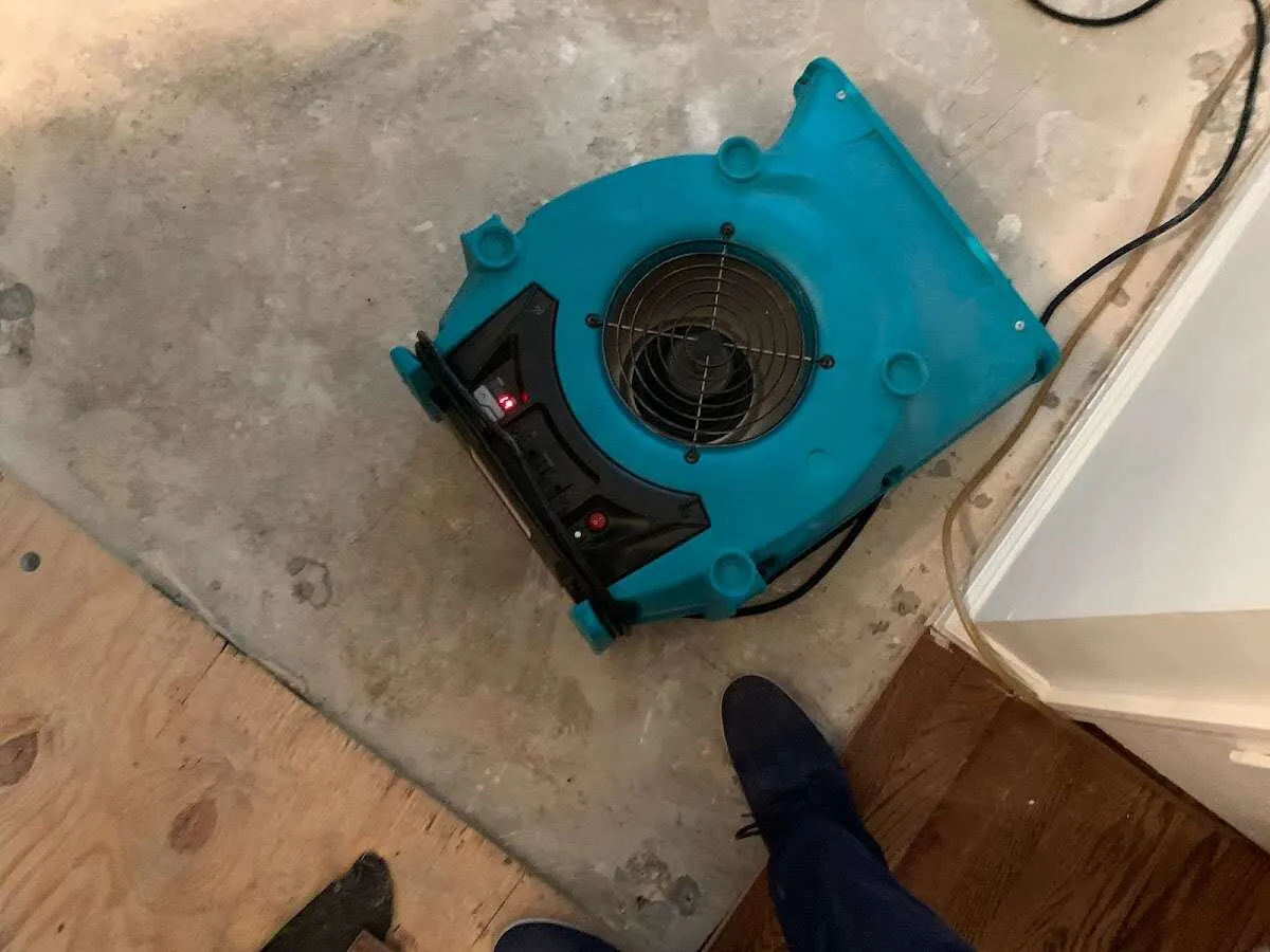 Air mover drying subfloor during Commercial Water Damage Restoration in Pacific Grove